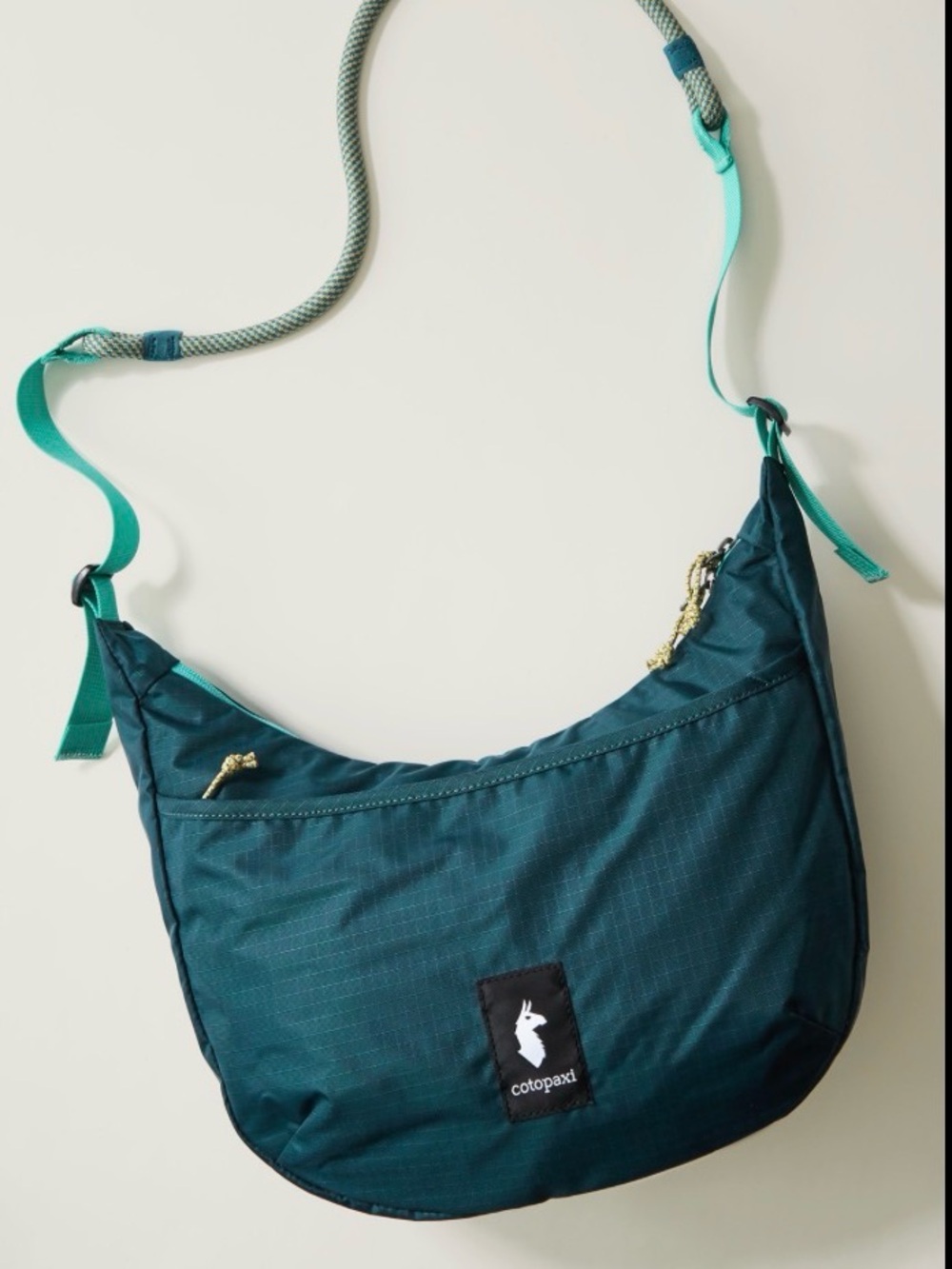 NWOT Cotopaxi deep teal crescent crossbody with aqua strap accents